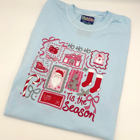 Light blue t-shirt with Christmas-themed design and text on a white background