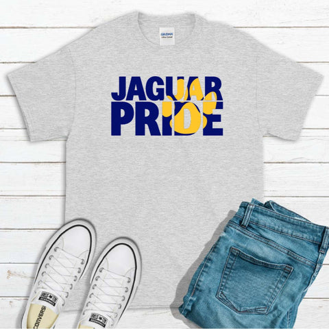 Gray t-shirt with 'Jaguar Pride' text, white sneakers, and blue jeans on a wooden surface